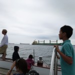 Sailing by an anchored cargo ship on the Chesapeake Bay.