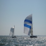 Donnybrook (80+ foot race boat) sailing through the fleet of Hospice Cup