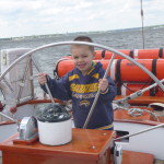 Captain Corbin steering the Schooner Woodwind